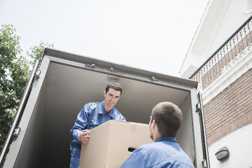 Professional man and van service handling boxes in Islington